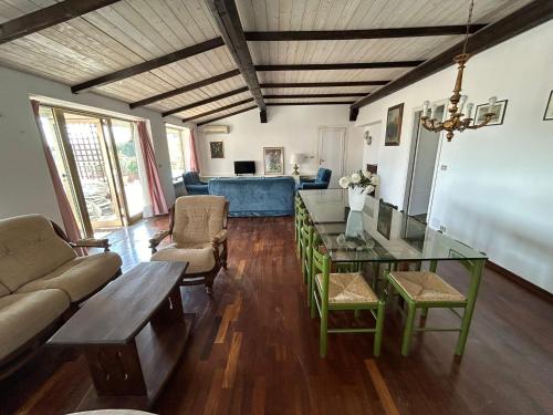a living room with a glass table and a couch at Attico Zamagna in Cesenatico