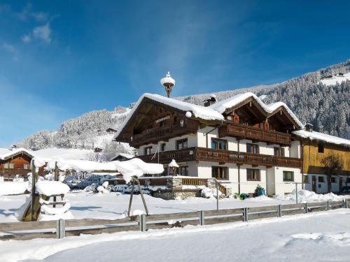 a house in the snow with a mountain at Apartment Heisenhaus-1 by Interhome in Ramsau im Zillertal