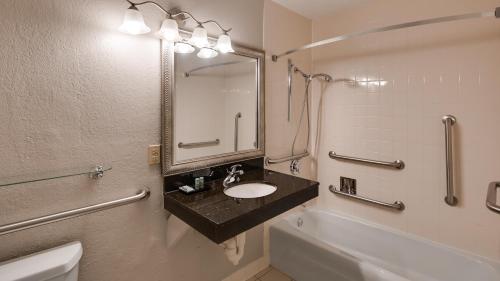 a bathroom with a sink and a tub and a toilet at Best Western Tomah Hotel in Tomah