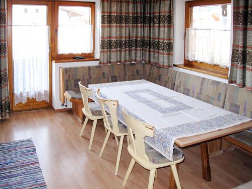 a dining room with a table and chairs at Apartment Josef - ZAZ590 by Interhome in Aschau