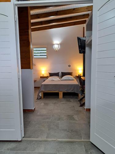 a bedroom with a bed in the middle of a room at ZimZim in Le Gosier