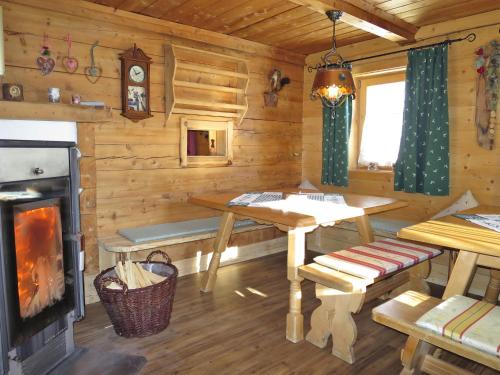 a log cabin with a table and a fireplace at Chalet Simonhütte - MHO640 by Interhome in Hippach