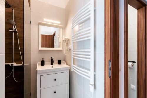 a bathroom with a white sink and a mirror at Comfy New apartment at Castle in Budapest