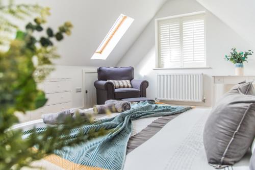 a living room with a couch and a chair at Kingsmead - Bracklesham Bay in Chichester