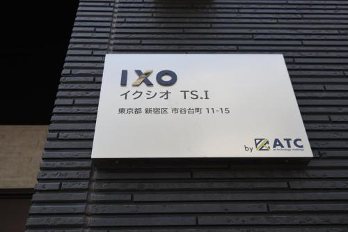 a sign on the side of a building at IXO Ts2 in Tokyo