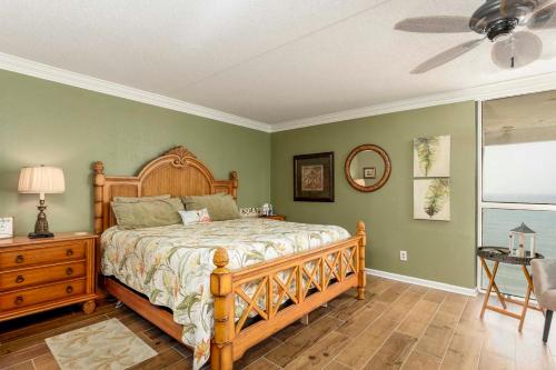 a bedroom with a bed and a ceiling fan at Oceanfront Custom and what a view of the ocean in Myrtle Beach