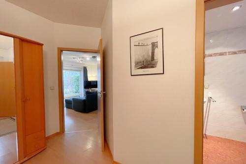 a hallway with a door and a picture on a wall at Haus Berlin Ferienwohung 1 in Kolpinsee
