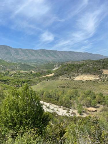 a view of a valley with mountains in the background at Lake Campground Silvano in Berat