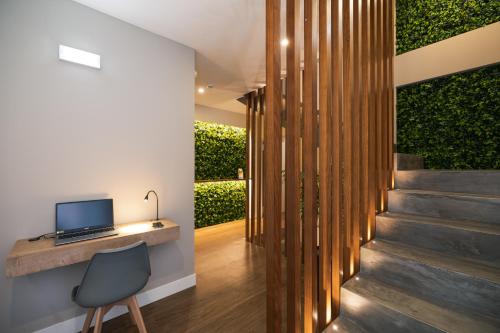 a home office with a desk and a laptop at Monturi Hostel in Ponta Delgada