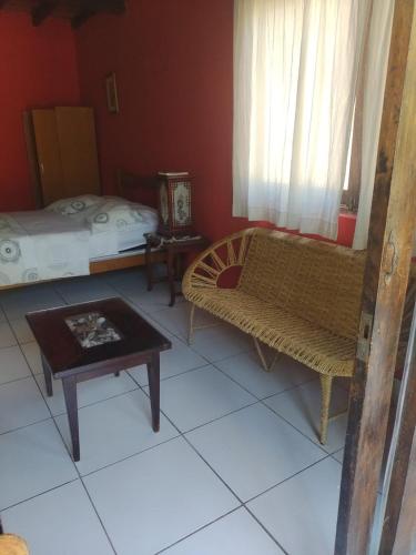 a living room with two beds and a table at Punta Pacífico Bungalows Máncora in Máncora