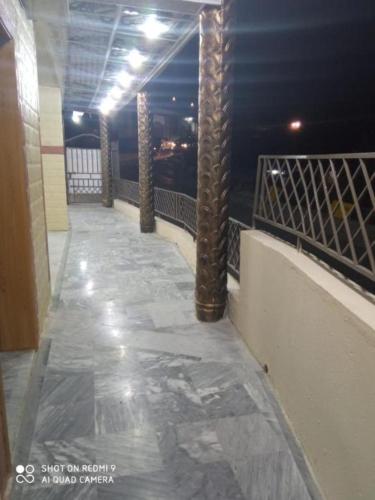a balcony with columns and a view of the ocean at Al Sadiq Guest House in Murree