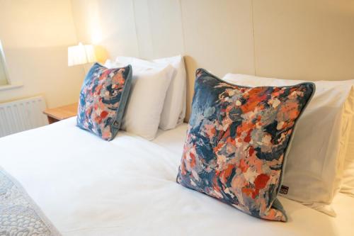 a bed with two pillows on top of it at The Western Citypoint Apartments in Galway