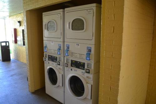 two washing machines are stacked against a wall at Dayspring Extended Stay in Greensboro