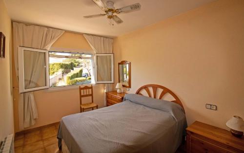 a bedroom with a bed and a window at Villa privada a 350 metros del mar ALCOSSEBRE Albert Villas in Alcossebre