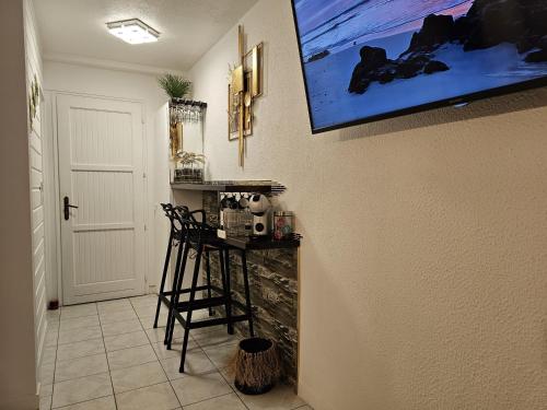 a room with a counter and a painting on the wall at Sweet Crépuscule - Studio avec Vue Mer Imprenable & Piscine in Les Trois-Îlets