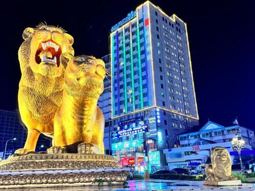 西哈努克的住宿－怡程酒店ECHENG HOTEL，一座大楼前的金狮雕像