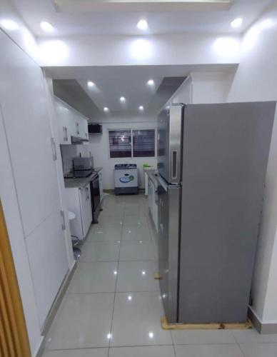 a large white kitchen with a refrigerator in it at APT Estevez in Pantoja