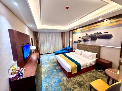 a hotel room with a bed and a television at 怡程酒店ECHENG HOTEL in Sihanoukville