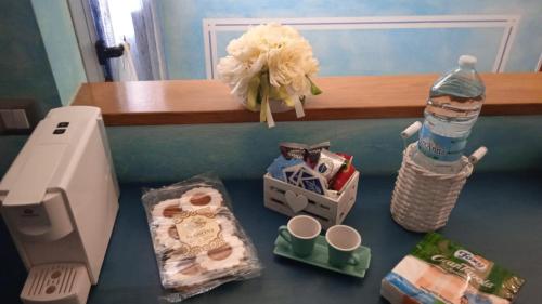 a counter with a toilet and a bottle of water at Casa vacanza Leonida in Carrara