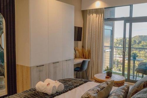 a hotel room with a bed and a balcony at Luxury Menlyn Maine Apartment in Pretoria