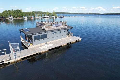 a house on a dock on a large body of water at Saunalautta Sisu in Imatra