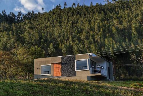 a small house on the side of a hill at El Encanto Hotel Boutique in Duitama