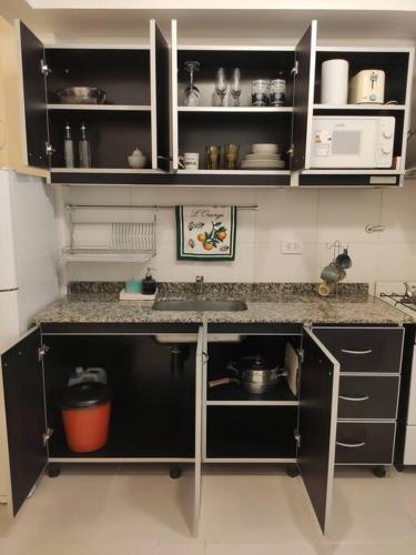 a kitchen with a sink and a counter top at Fortunati Departamentos in General Sarmiento