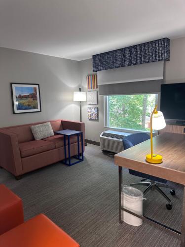 a living room with a couch and a table at Hampton Inn & Suites Tallahassee I-10-Thomasville Road in Tallahassee