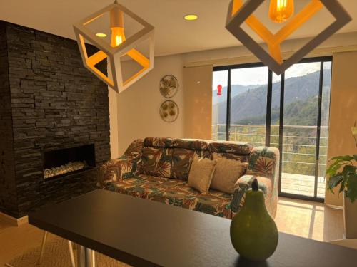 a living room with a couch and a fireplace at El Encanto Hotel Boutique in Duitama