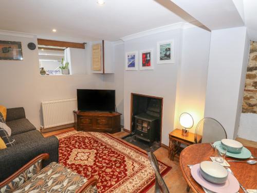 a living room with a couch and a fireplace at 5A Castle Street in Ryde