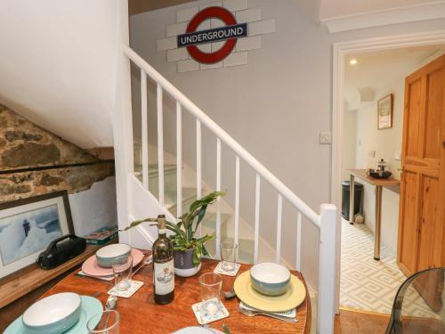 a table with plates and wine glasses on top of a staircase at 5A Castle Street in Ryde