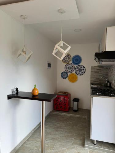 a kitchen with a table and plates on the wall at El Encanto Hotel Boutique in Duitama