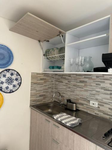 a kitchen with a sink and a counter top at El Encanto Hotel Boutique in Duitama