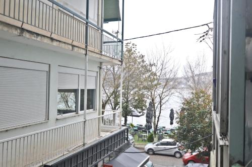 un balcon d'un immeuble avec des voitures garées dans la rue dans l'établissement Georgia's lakeside house, à Kastoria