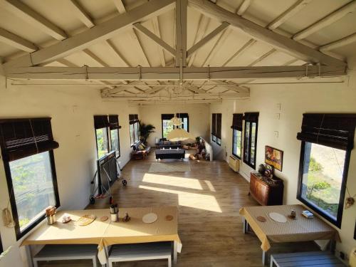 a large living room with tables and windows at Cal Gat in Les Planes d'Hostoles