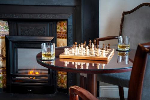 a chess set on a table in front of a fireplace at The Western Hotel in Galway