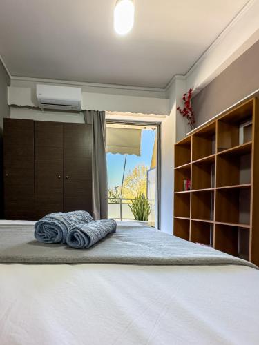 a bedroom with a bed with towels on it at Downtown golden apartment in Kalamata