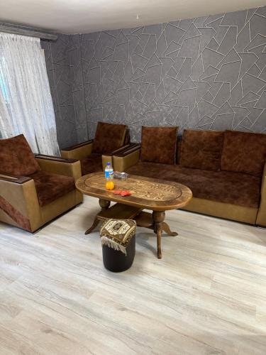 a living room with a couch and a coffee table at Zvartnoc House in Ejmiatsin