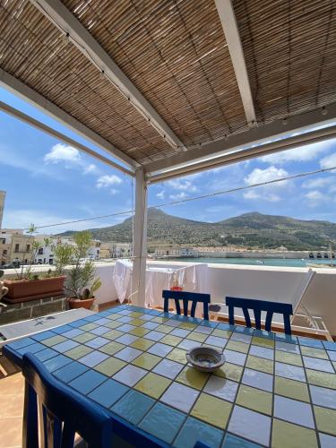 a table on a patio with a view of the ocean at Casa Emma in Favignana