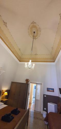 a living room with a chandelier hanging from a ceiling at Affittacamere Museo in Taranto