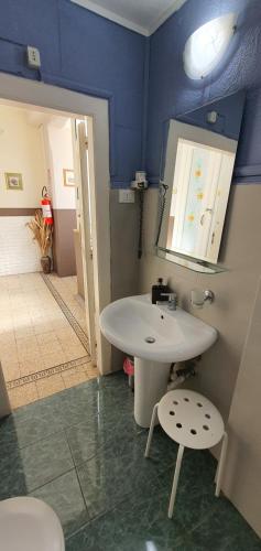 a bathroom with a white sink and a mirror at Affittacamere Museo in Taranto