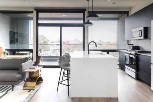 a kitchen with a white island in a room at Luxury Apartment Private Terrace in Chicago