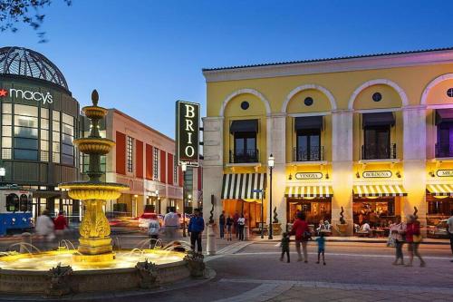 a fountain in the middle of a street in a city at Life's a Beach in Lake Worth