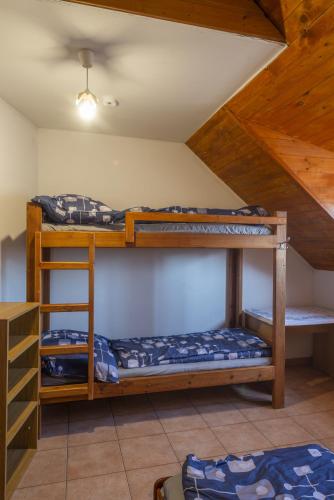 a room with three bunk beds in a attic at mlyn-osvracin in Osvračín