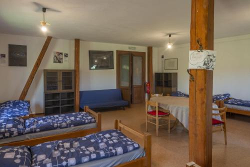 a room with several beds and a table in it at mlyn-osvracin in Osvračín