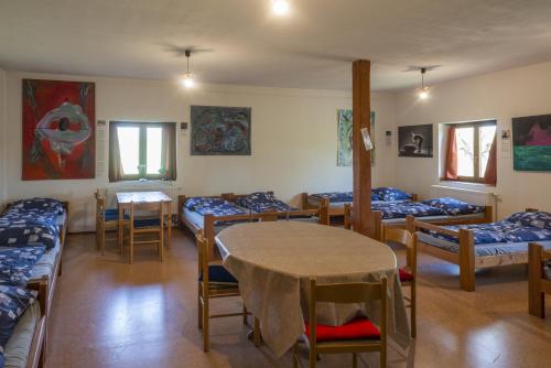 a room with beds and a table and chairs at mlyn-osvracin in Osvračín