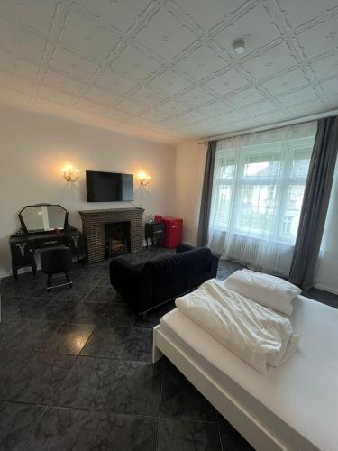 a living room with a couch and a fireplace at King David Garden in Berlin