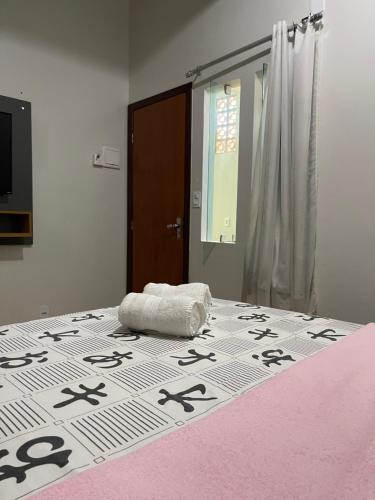a bedroom with a large bed withinese writing on it at Hospedaje MorroSP in Morro de São Paulo