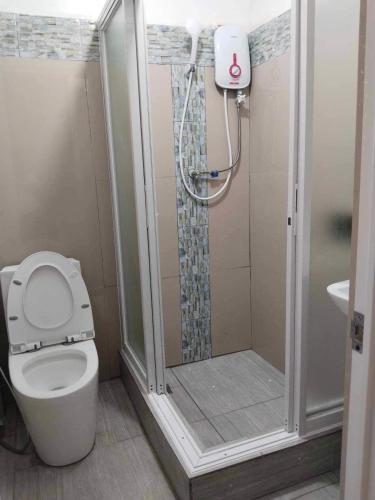 a bathroom with a shower and a toilet at Kathy's Place at Sto Niño Cold Spring in Catarman