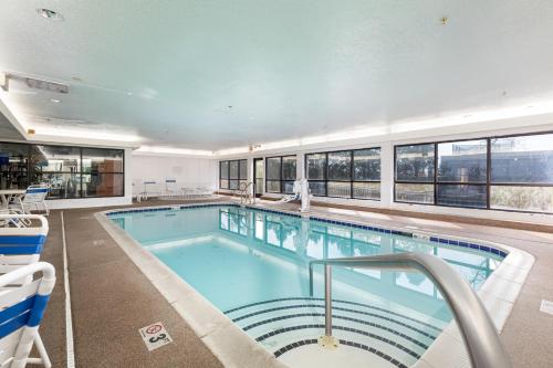 a large swimming pool in a building with windows at Comfort Suites Lombard/Addison in Lombard